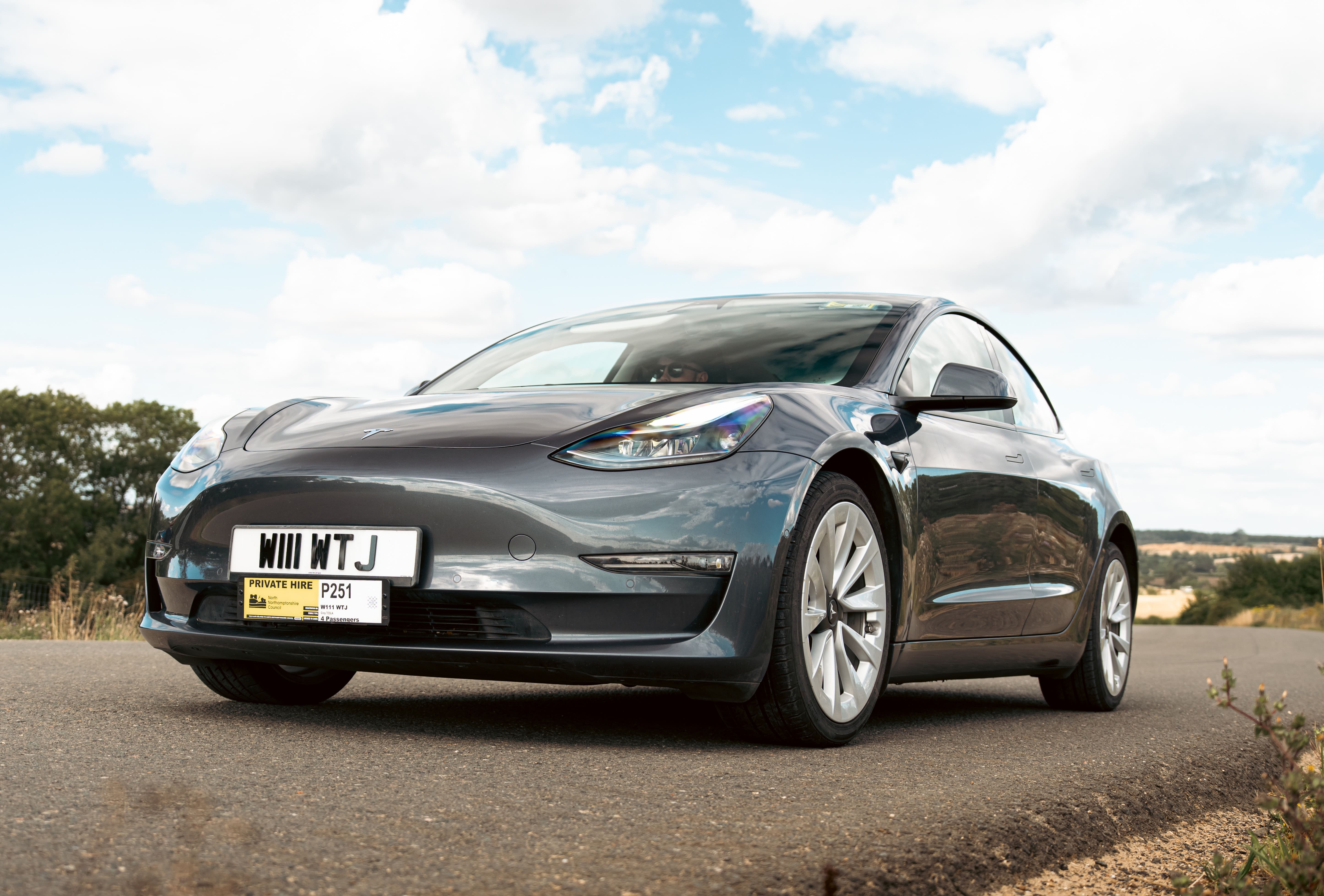 Electric car on a road with a clear sky